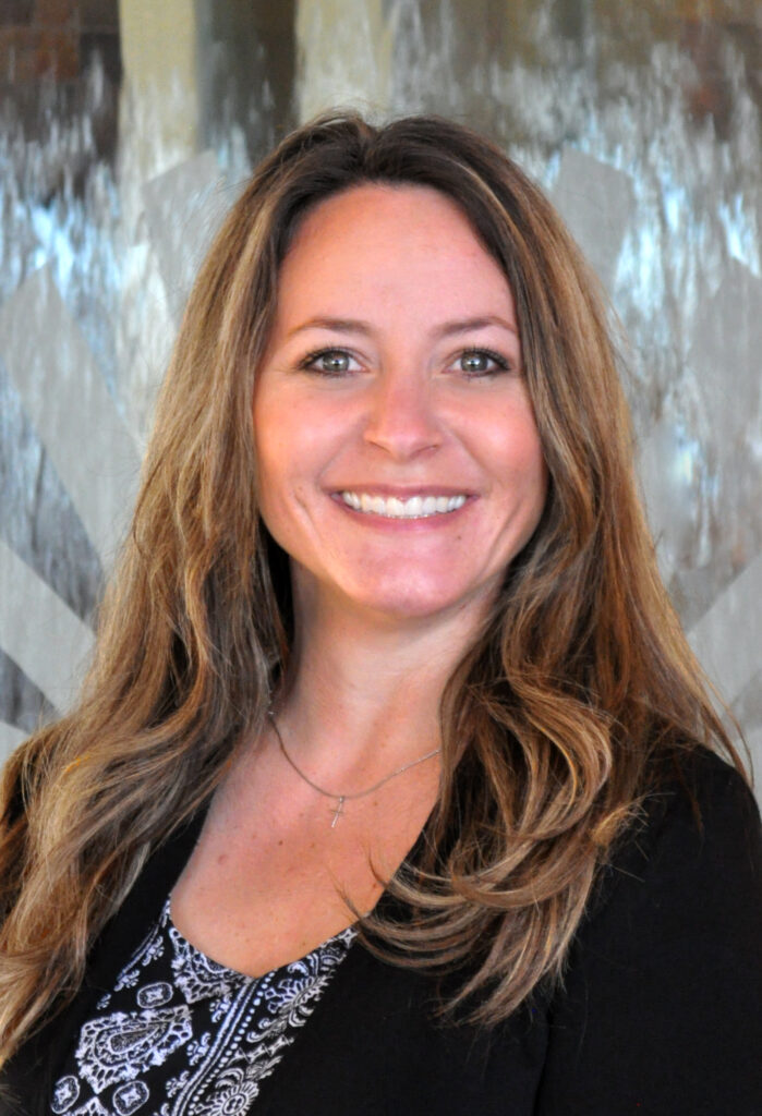 Headshot of Jaime Shanks, a white woman wearing a black shirt.